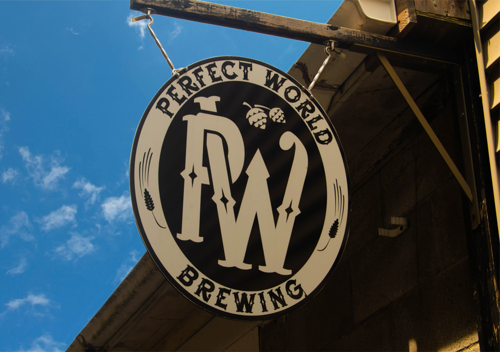 Perfect World Brewing logo hanging above entrance.